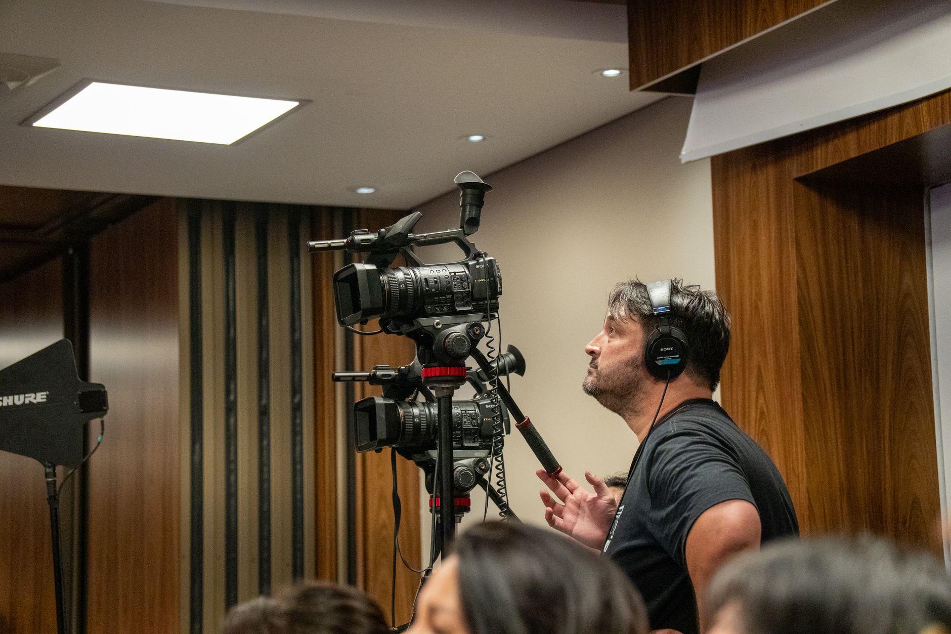 professional cameraman at indoor event